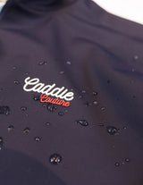 Navy Golf Vest with 'Caddie Couture' logo on a white background. with Droplets of water on