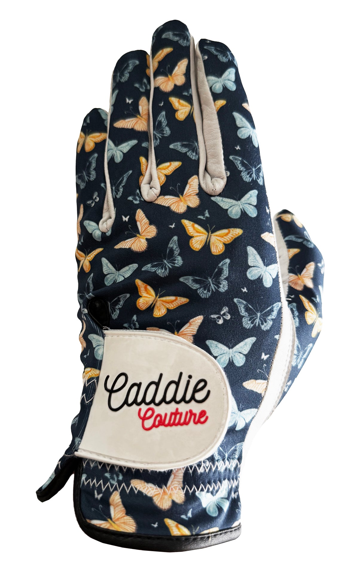 Glove with butterfly pattern and 'Caddie Couture' label on a white background