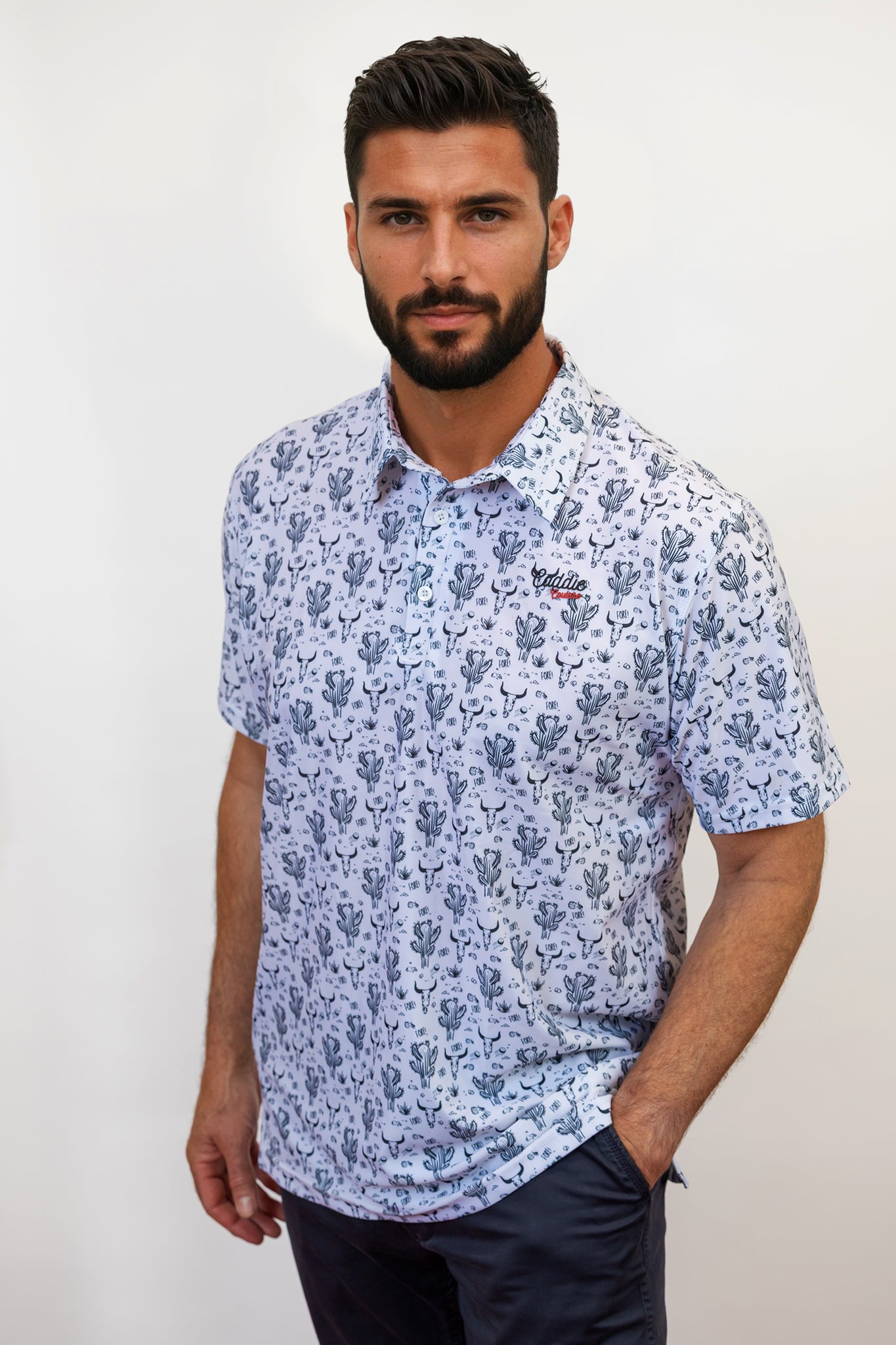 Man wearing a cactus golf shirt with hand in pocket
