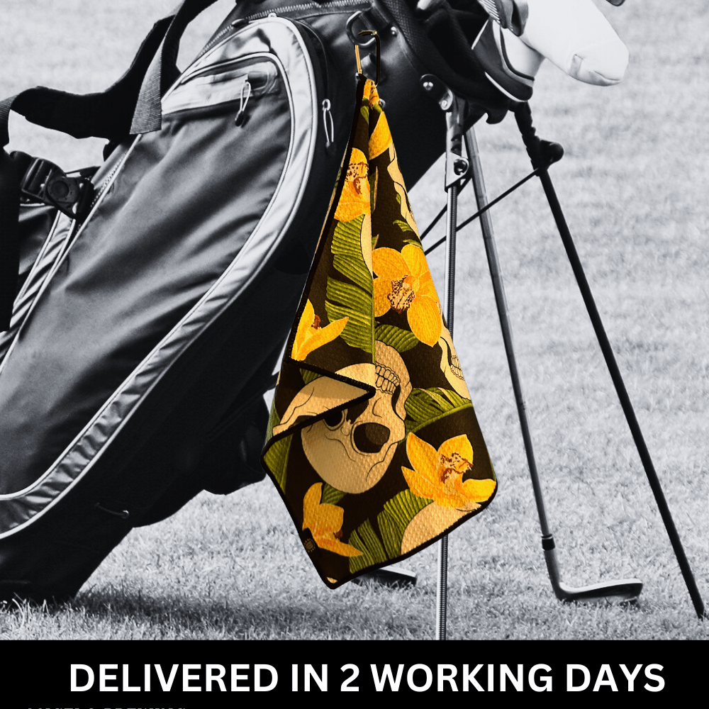 A golf towel with a camouflage pattern hanging on a golf bag, attached by a bag hook.