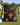 Black drawstring pouch with colorful designs on a golf course