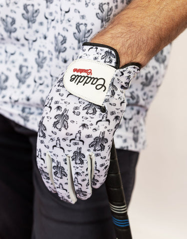 Glove with a brand logo worn by a person, on a light background