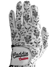 Golf glove with cactus pattern and 'Caddie Couture' branding on a white background