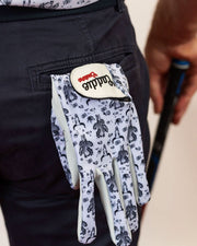 Golf glove with a pattern on a person's hand holding a golf club.