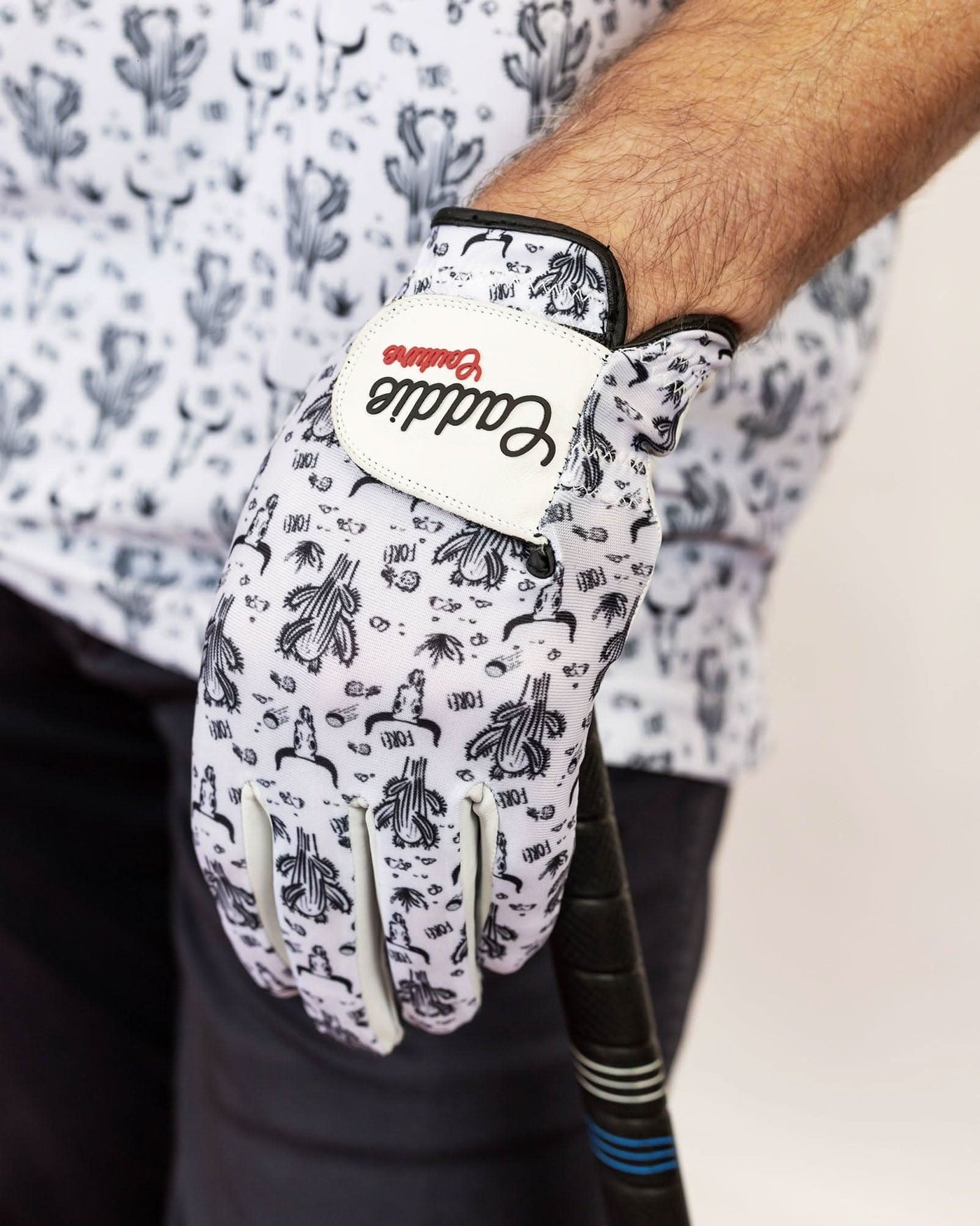 Glove with a brand logo worn by a person, on a light background