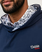 Man wearing a navy blue hoodie with a patterned collar and 'Caddie Couture' branding.
