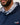 Man wearing a navy blue hoodie with a patterned collar and 'Caddie Couture' branding.