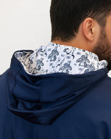 Navy blue golf hoodie with a patterned hood lining on a plain background