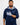 Man wearing a navy blue golf hoodie with floral patterns on a white background