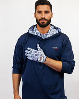 Man wearing a navy blue golf hoodie with floral patterns on a white background