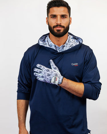 Man wearing a navy blue golf hoodie with floral patterns on a white background