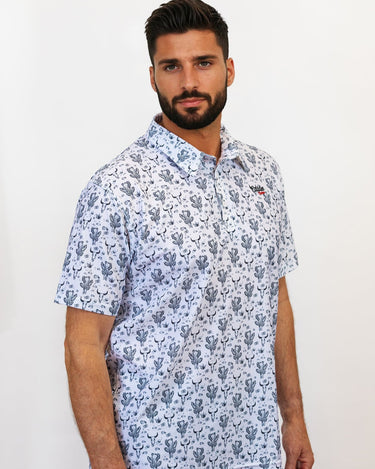 Man wearing a cactus and bull golf polo side facing