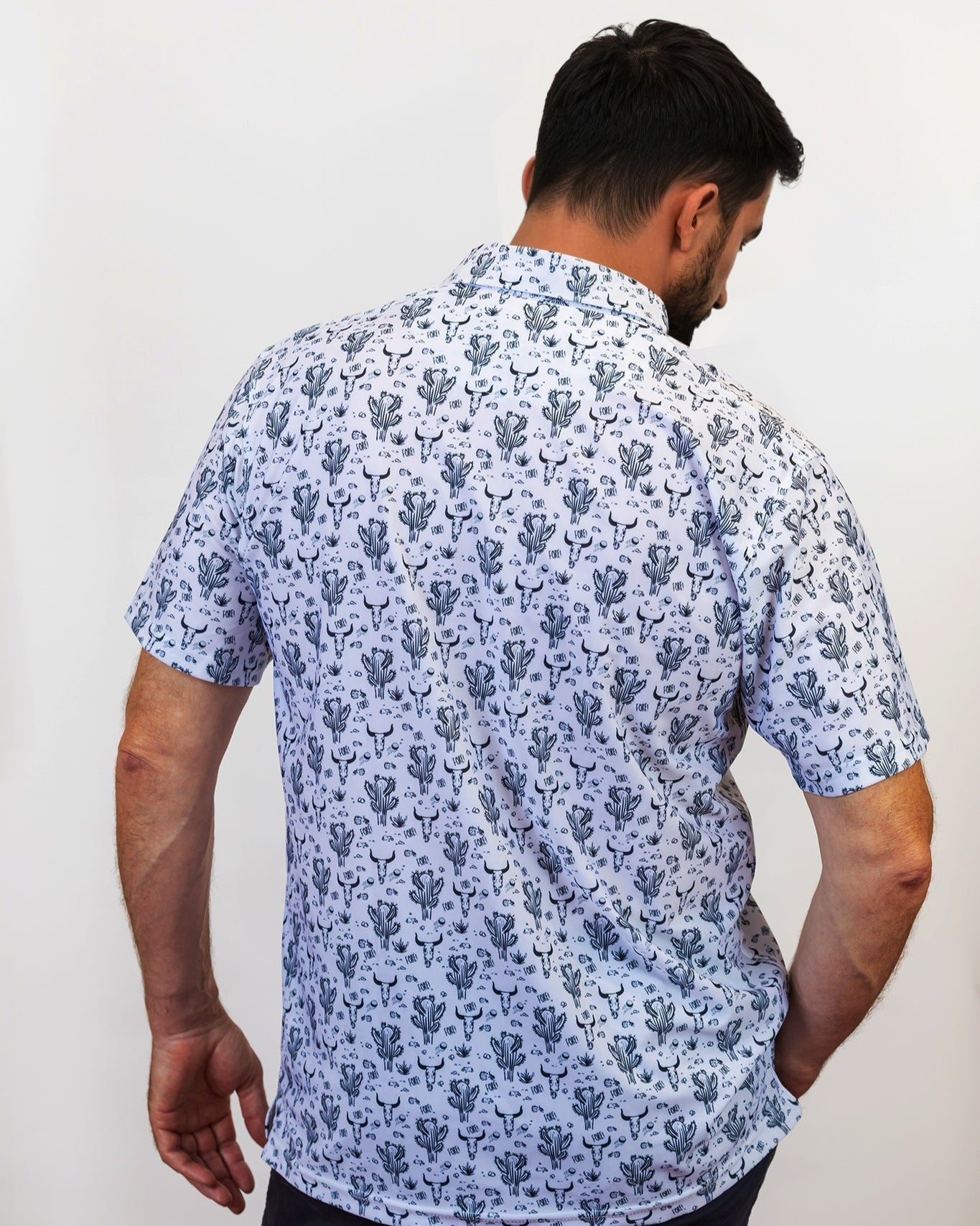 Man Wearing Cactus and Bull Golf Polo Untucked with back to the camera