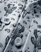 White shirt with black cactus and 'FORE!' pattern, featuring a caddie couture button.