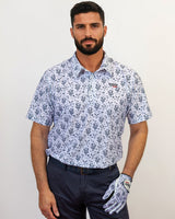 Man wearing a patterned shirt and golf glove on a plain background