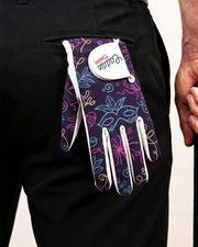 Colorful patterned glove with a brand tag on a black background