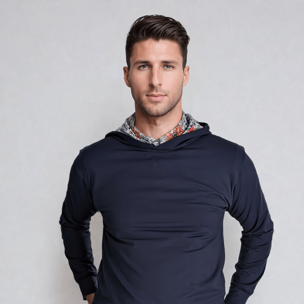 A male model wearing a navy blue hoodie with vintage floral print detailing on the hood.