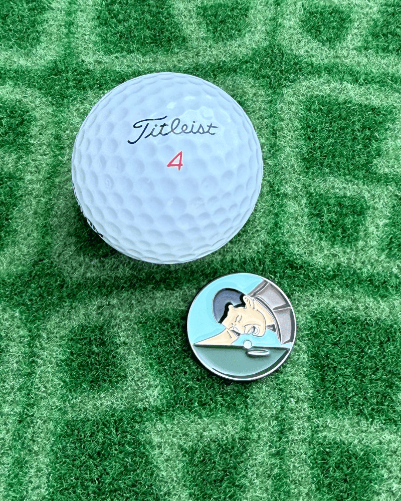 Happy Gilmore Golf Ball marker next to white golf ball