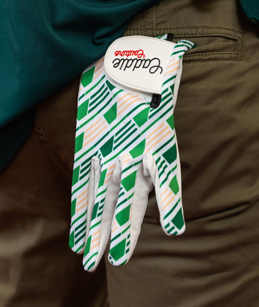Golf glove with green and white pattern on a brown background