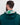 Person wearing a green golf hoodie with a patterned hood against a white background