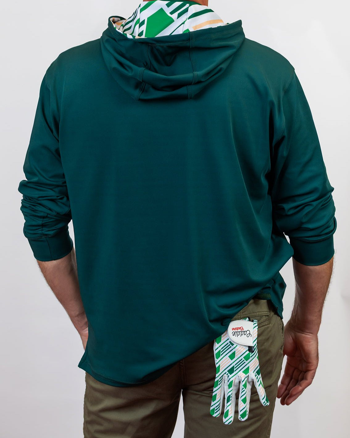 Person wearing a green golf hoodie with a white background