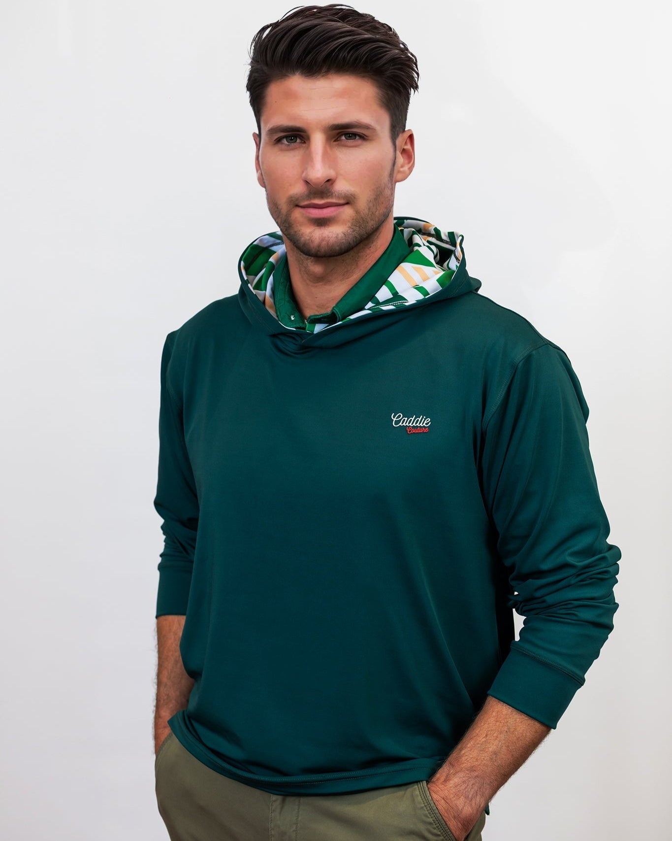 Man wearing a green golf hoodie with a brand logo on a white background