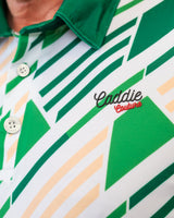 Close-up of a green and white patterned golf shirt with 'Caddie Couture' branding.