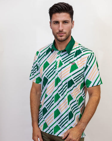 Man wearing a patterned golf shirt with green and white geometric design on a plain background