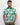 Man wearing a patterned green and white golf shirt with a plain background