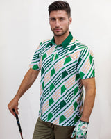 Man wearing a patterned golf shirt and holding a golf club on a plain background