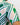 Close-up of a green and white geometric patterned golf shirt with a blurred background