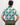 Man wearing a patterned golf shirt with green, white design on a plain background