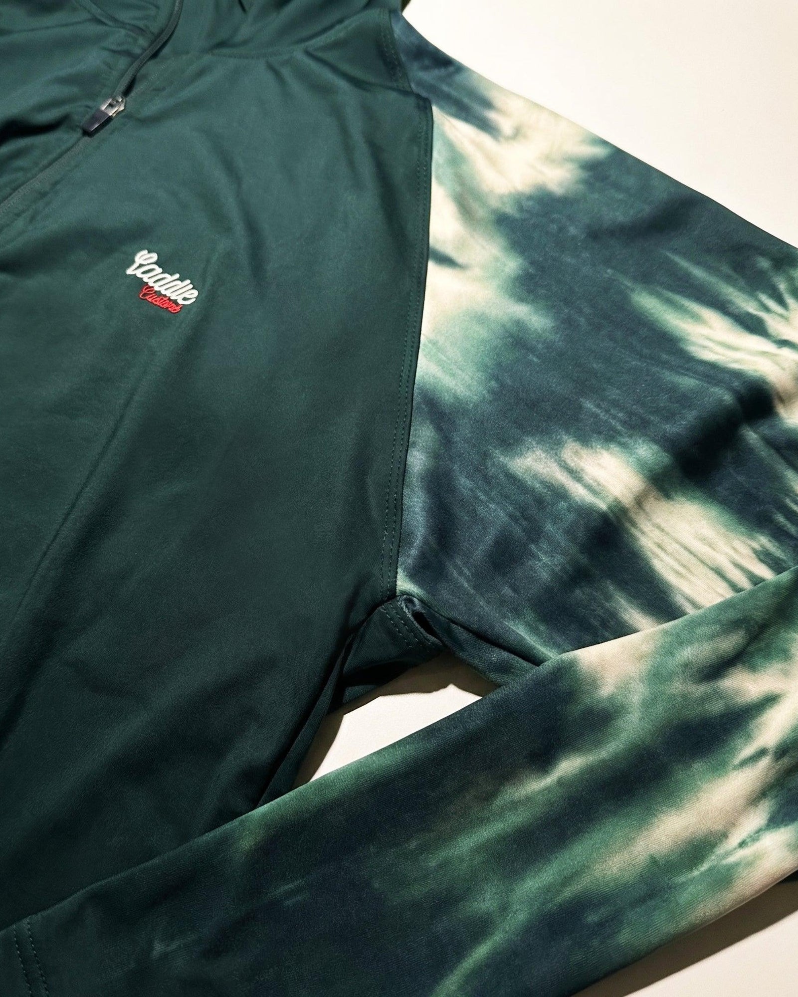 Close-up of Fairway Camo Quarter Zip zip, seams and Caddie Couture branding
