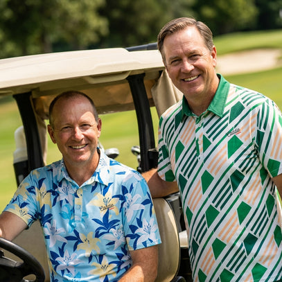 Two men in patterned shirts sitting in a golf cart on a golf course