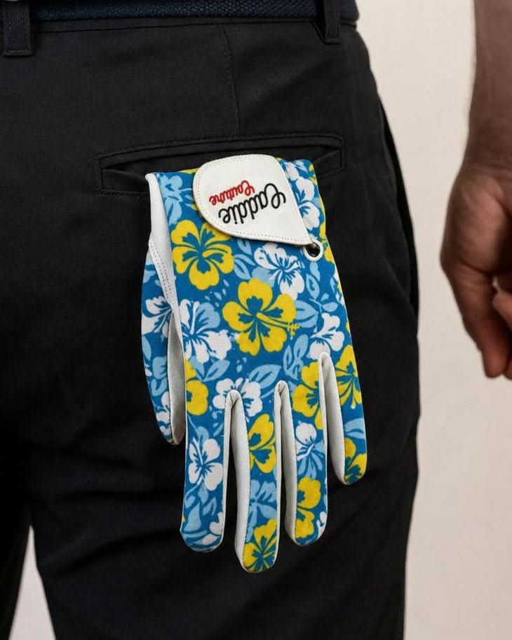 Blue floral-patterned golf glove with a white brand label on a black background