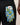 Blue floral-patterned golf glove with a white brand label on a black background