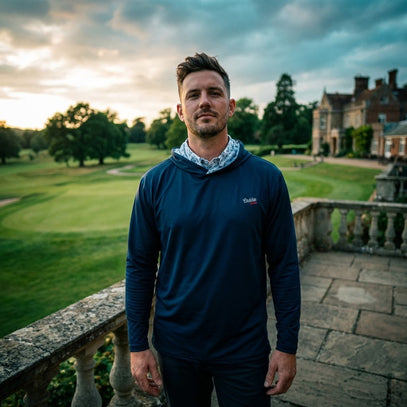 Man standing on a balcony with a scenic background of a house and greenery
