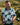 Man holding a golf club in a grassy outdoor setting