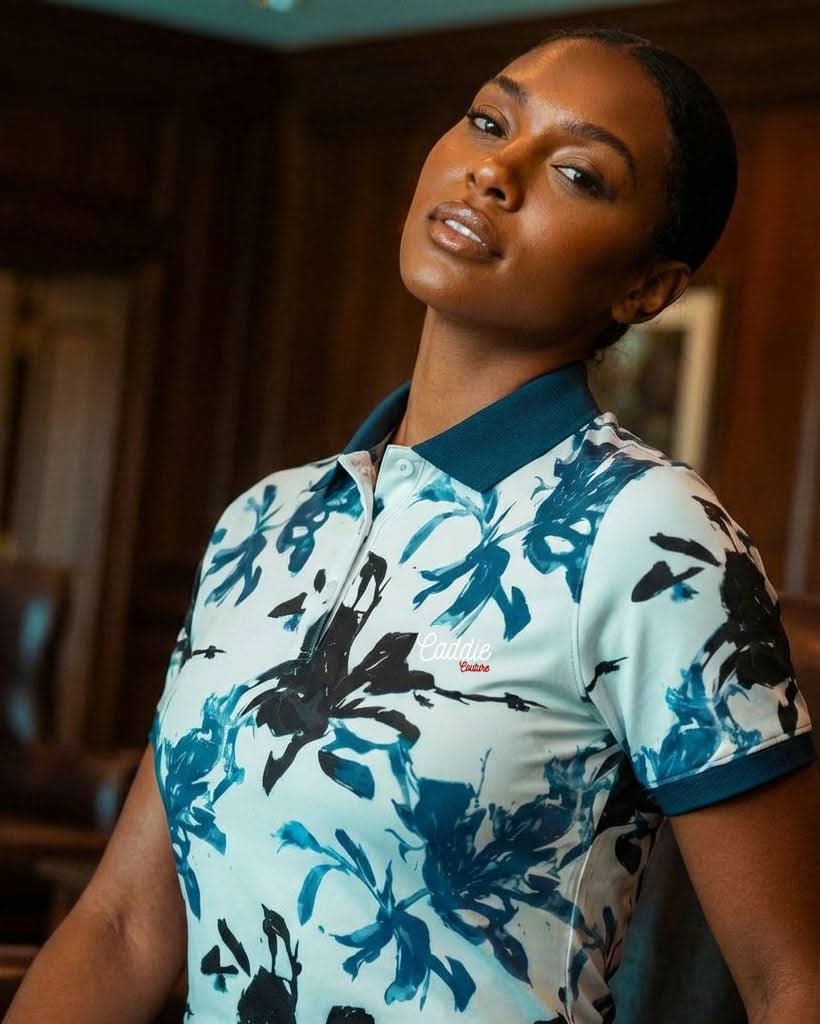 Woman wearing a floral-patterned shirt in an indoor setting