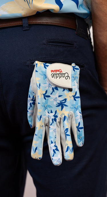 Floral-patterned glove with a brand logo on a dark background