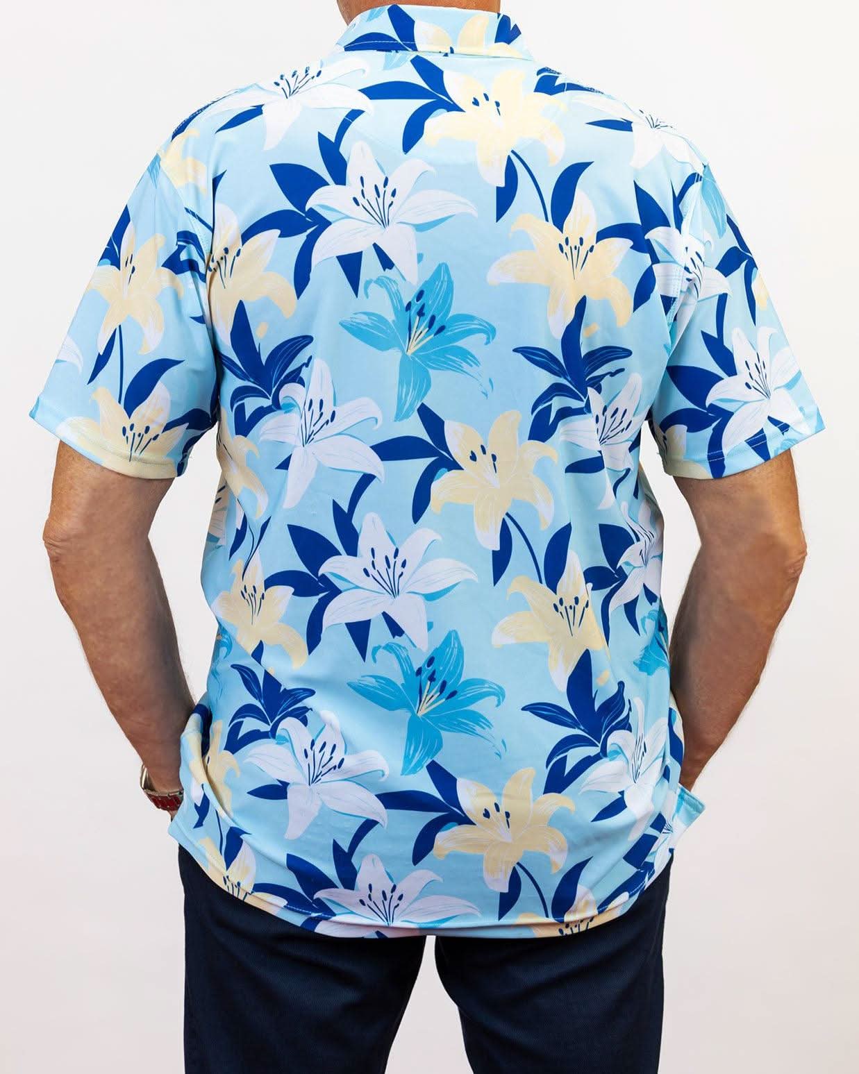 Person wearing a blue floral patterned golf shirt on a plain background