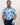 Man wearing a blue floral golf shirt and dark pants, holding a golf club with a white background