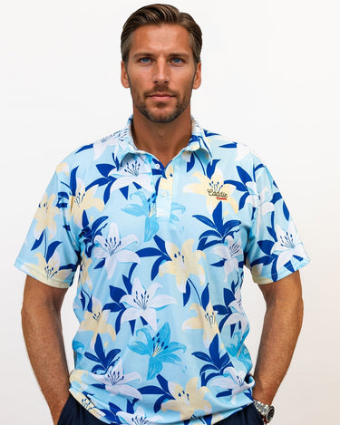 Man wearing a blue floral patterned golf shirt against a white background