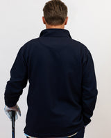 Man wearing golf quarter zip with floral pattern. holding golf club