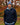 Man wearing a navy blue caddie couture Qzip, standing in an autumn park.