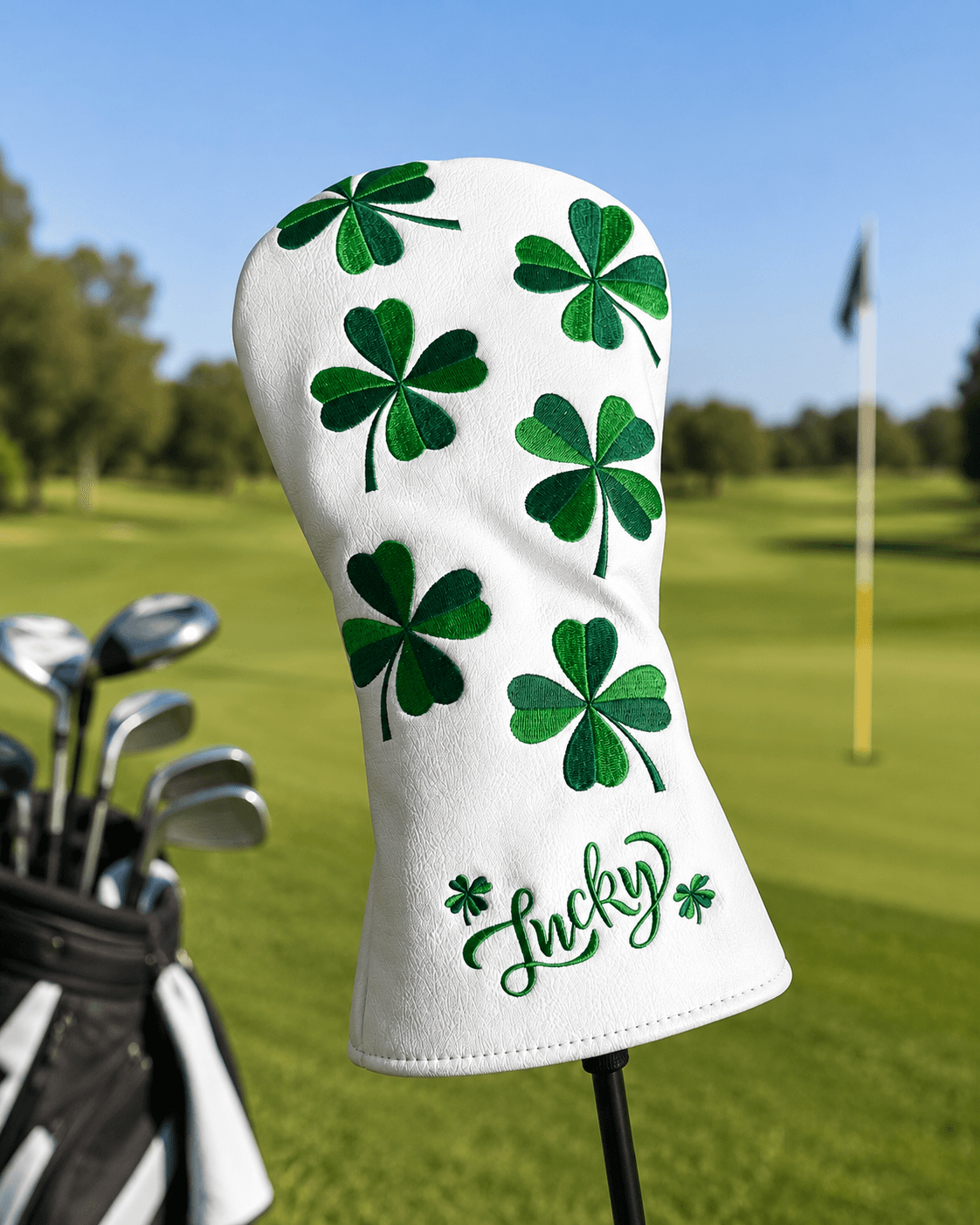 Golf club head cover with green shamrocks and 'Lucky' text on a golf course background