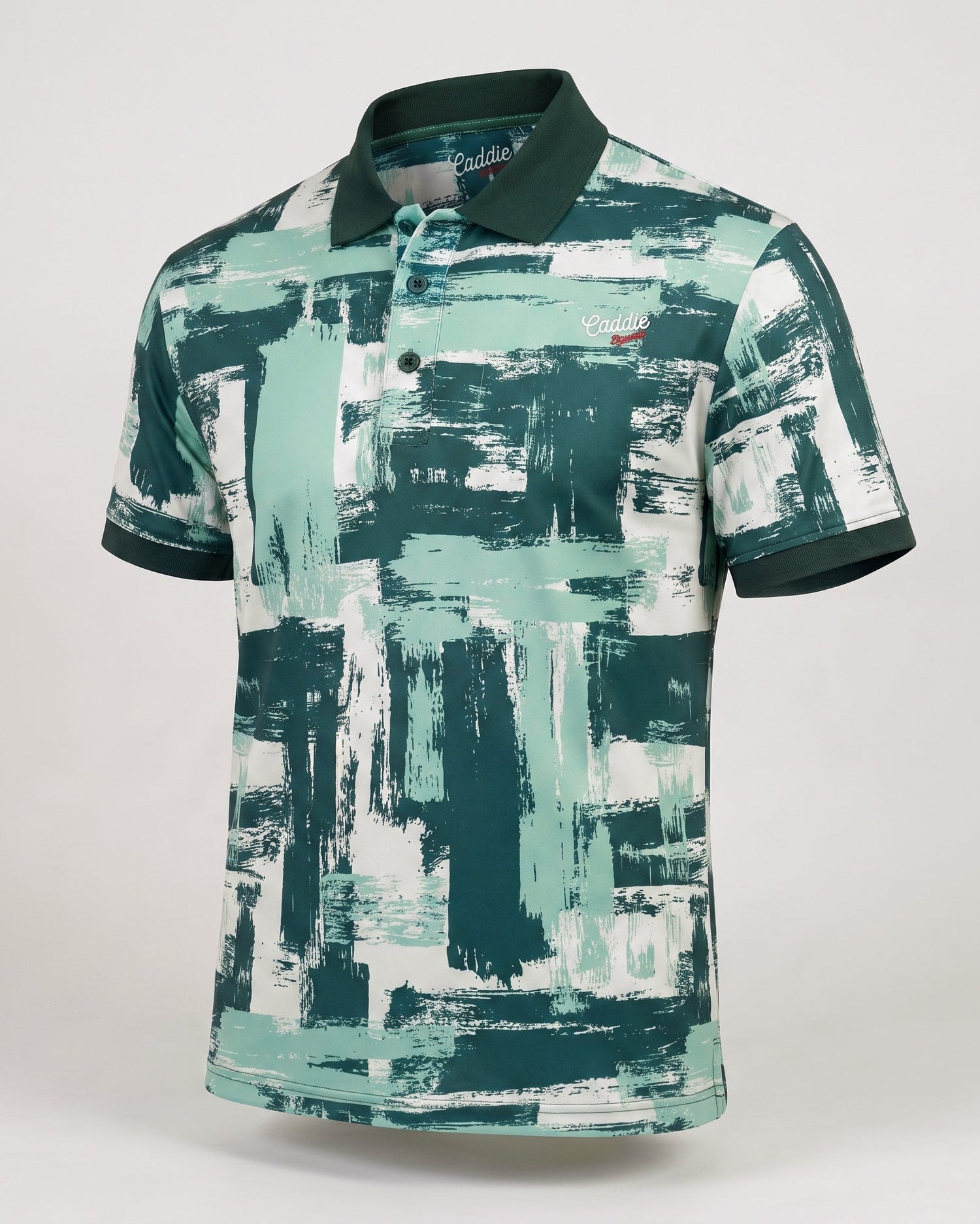 A short-sleeve polo shirt with a green, teal, and white abstract brushstroke pattern, featuring a dark green collar and sleeve cuffs, displayed on a neutral light gray background.