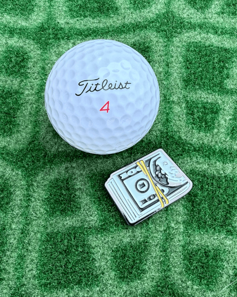 Money Clip Golf Ball marker next to Golf Ball