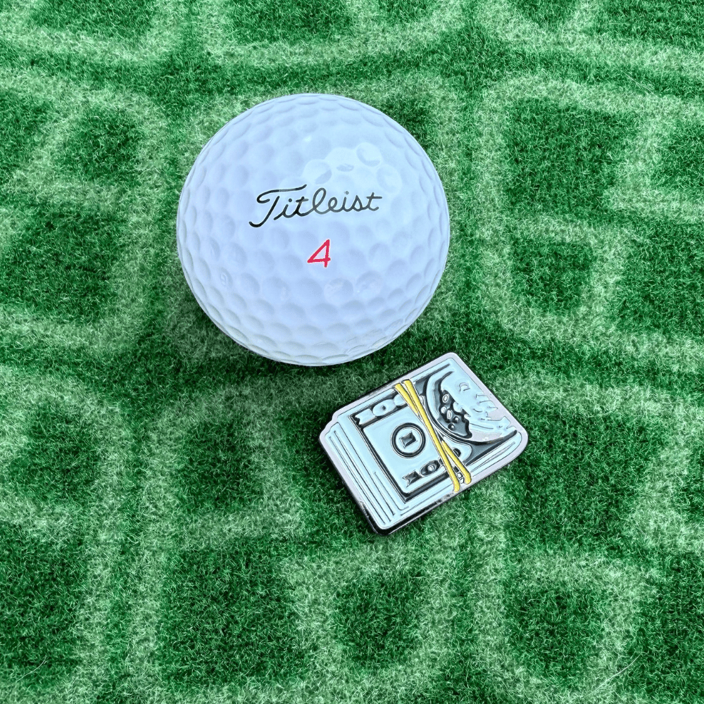 Money Clip Golf Ball marker next to Golf Ball