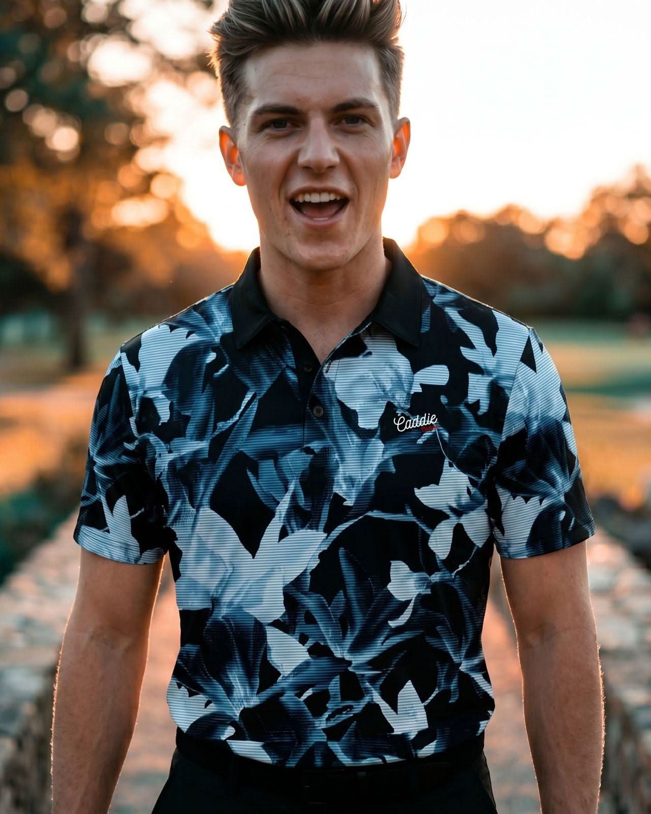 Man wearing a patterned shirt with a blurred outdoor background